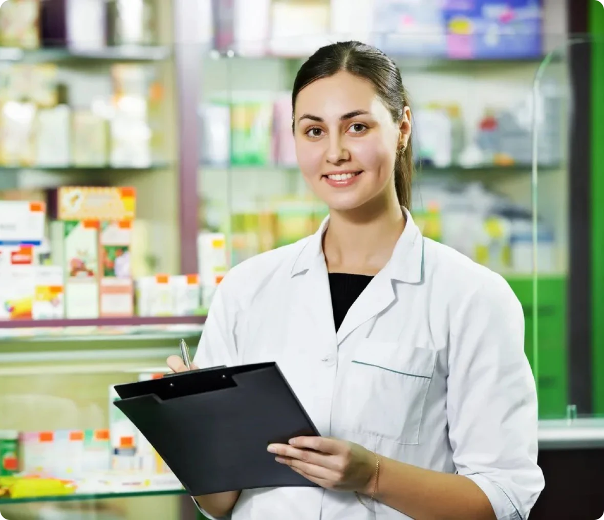 Smiling pharmacist in drugstore setting